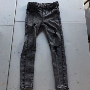 Black/grey ripped jeans.